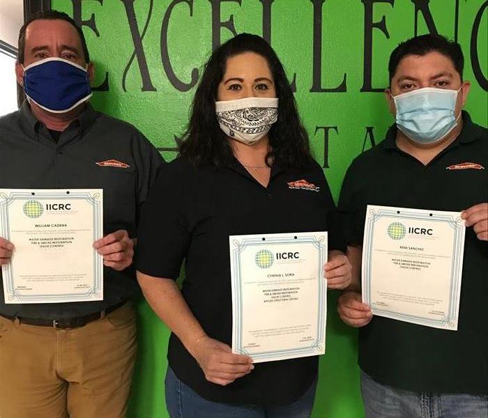 3 SERVPRO employees holding Their New Fire Certificates 